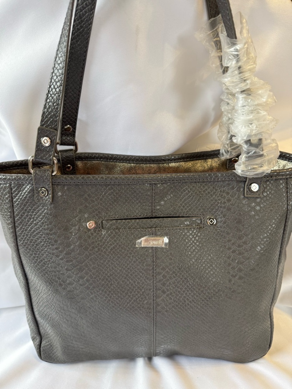 This item is a Jewell by Thirty-One Townsfair reversible tote in gray.